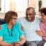 A couple sits with aging parents and enjoys their time together.