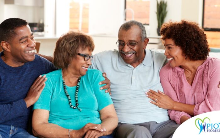 A couple sits with aging parents and enjoys their time together.